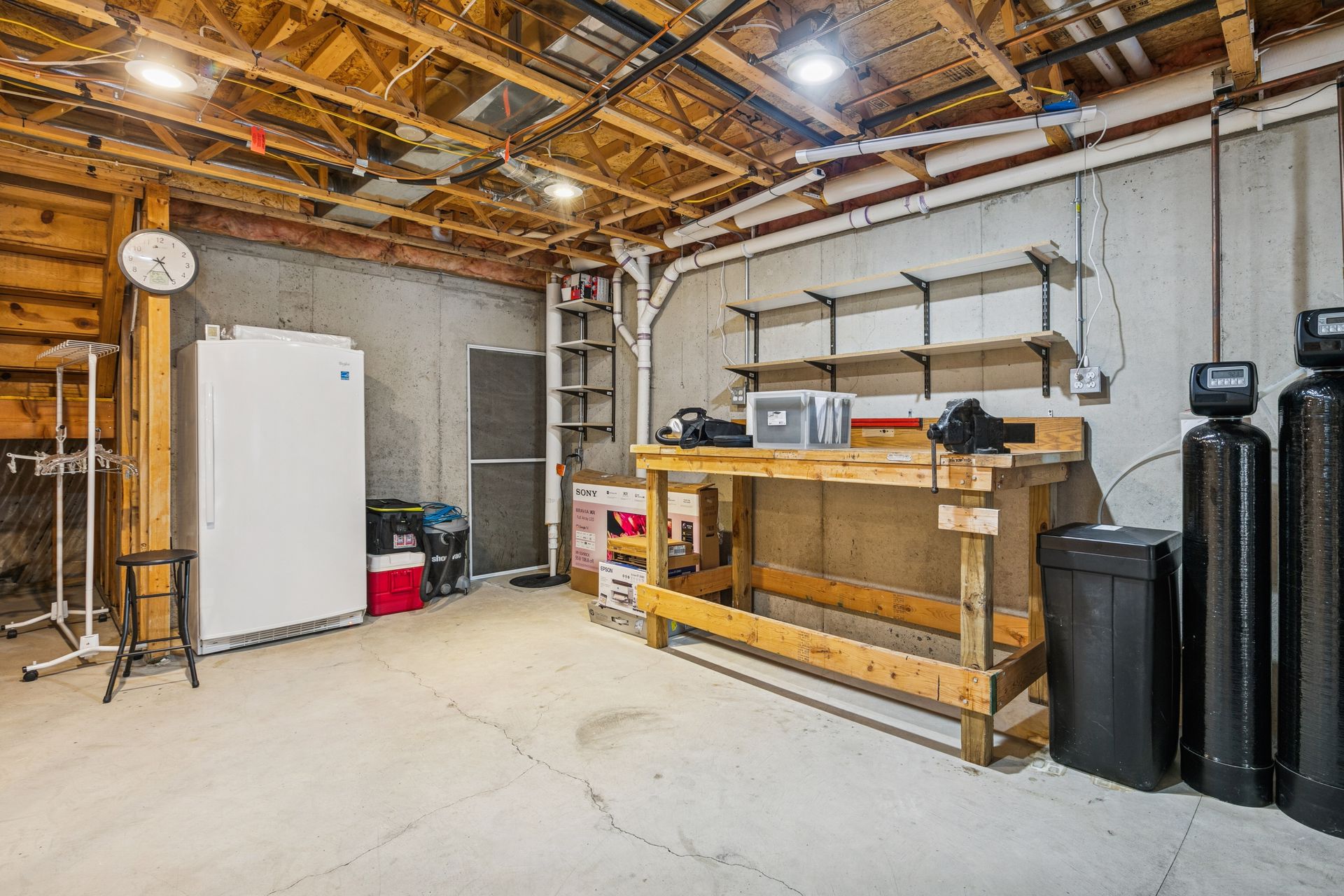 Unfinished lower level provides additional space ready for a second bedroom, and bathroom